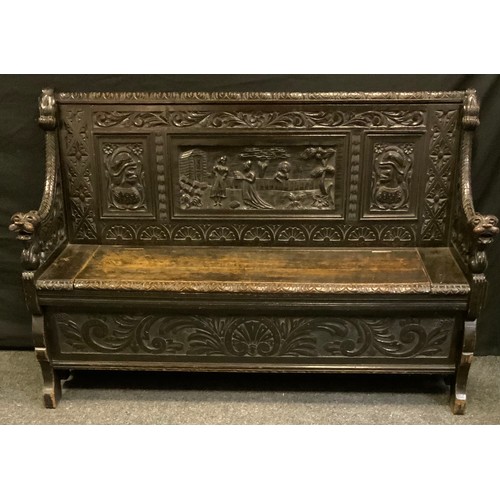 17 - A late 19th/early 20th century Gothic Revival Dutch style oak Monks bench, carved three panel figura... 