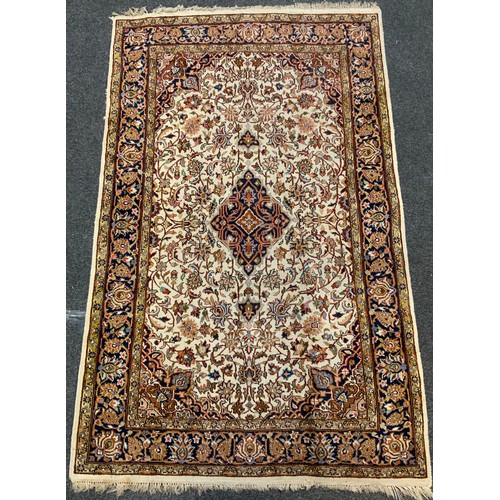 22 - A fine hand made Kashan rug, multi tone floral motif, cream ground, 206cm x 132cm