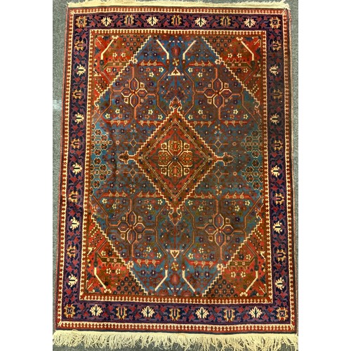 23 - An antique Persian hand made Joshaghan rug, in tones of blue, red, white, 155cm x 110cm