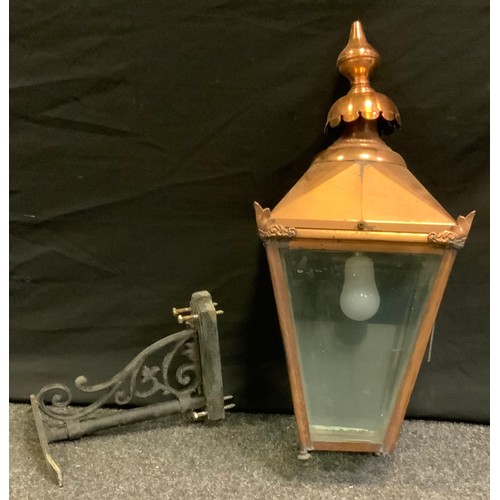 47 - A Copper pub, or street lantern, of tapering square form, cast iron bracket, with foliate scroll dec... 