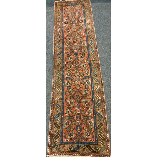 59 - An antique hand-knotted Kurdish runner, woven in shades of red, burgundy, green, and blue, 322cm x 8... 