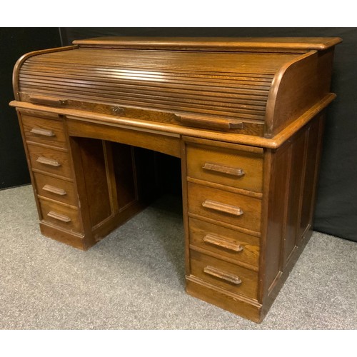 1 - An early 20th century oak  desk, tambour top enclosing fitted interior, single drawer over knee hole... 