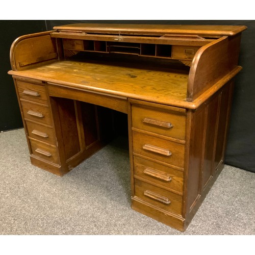 1 - An early 20th century oak  desk, tambour top enclosing fitted interior, single drawer over knee hole... 