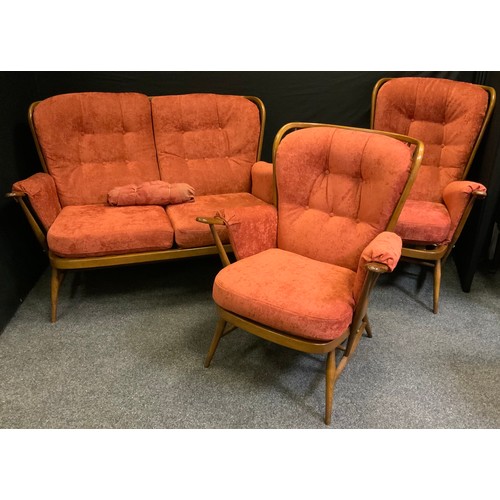 2 - An Ercol Windsor three piece suite, comprising a double seated sofa and two arm chairs.(3)