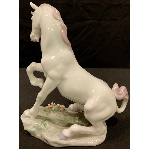 18 - A Lladro Privilege model of a Magical Unicorn, number 7697, 22cm, printed and impressed marks, dated... 