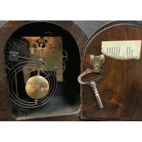 27 - An oak mantel clock, chiming; another oak Napoleon hat mantel clock (2)