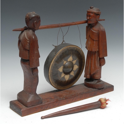 26 - A Chinese hardwood gong, held by attendants, 30cm high