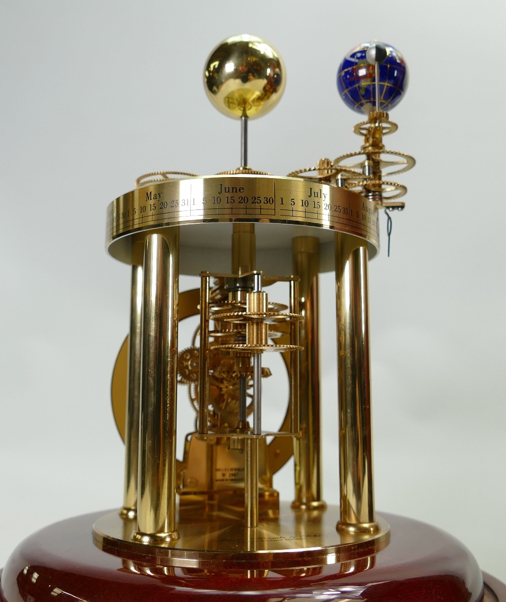 Franz Hermle & John quality Table clock A Richard Hermle design under glass dome in Mahogany case.