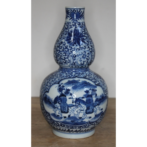 377 - A Chinese blue and white double gourd vase, bearing six character Kangxi mark to base, 20th century,... 