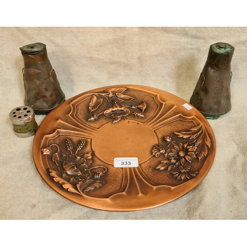 13 - An Arts & Crafts style copper plate decorated with flowers in relief, a pair of miniature milk churn... 