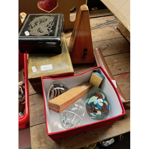 34 - A mixed lot including 3 paperweights, harmonica, metronome, small tripod, leather jewellery box and ... 