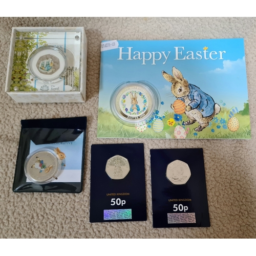 28 - A Peter Rabbit 2020 UK 50p silver proof coin, two Peter Rabbit 50p pieces, a Peter Rabbit commemorat... 