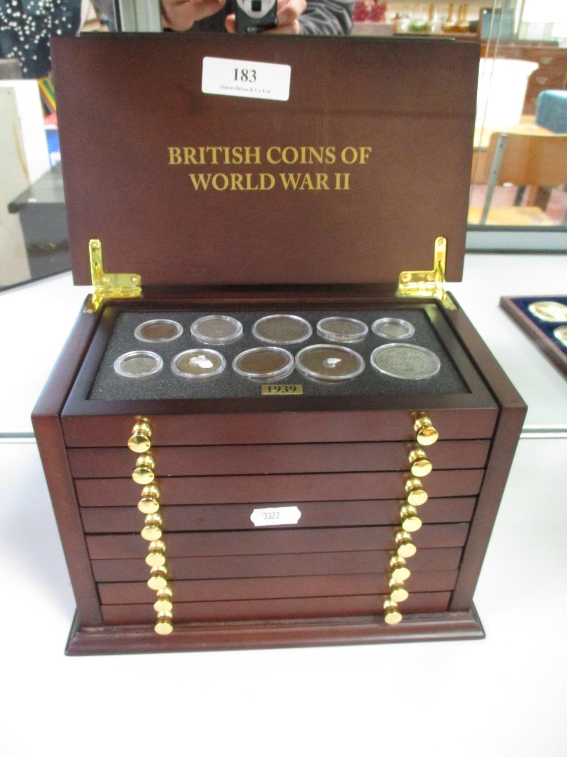 A mahogany coin of eight drawers containing a collection of