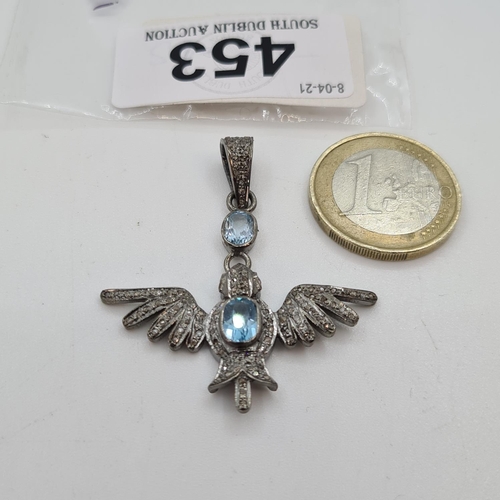 453 - Lovely Silver Bird pendent with Two oval natural blue topaz stones and Rose cut diamonds.