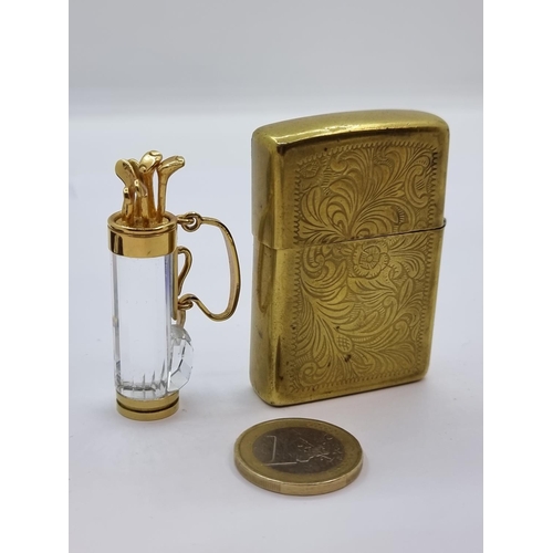 13 - Two items consisting of a very clean flint lighter by Zippo, finished with a very attractive foliate... 