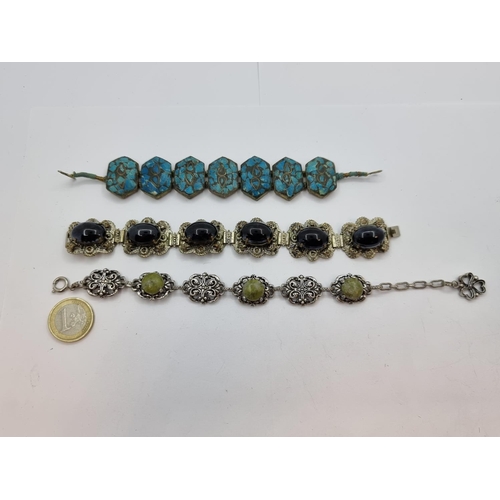 34 - A collection of three antique bracelets; the first with blue lapis polished stone set in silver moun... 