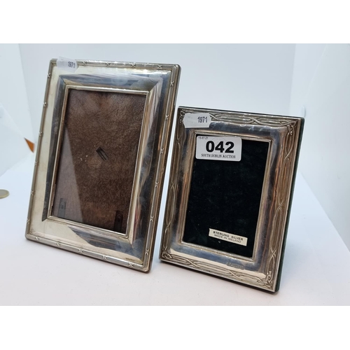 42 - Two Irish silver Celtic designed picture frames, with glazed fronts. Dimensions 18 x 14cm and 13.5 x... 