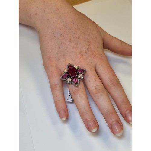53 - A stunning Sterling Silver Natural  ruby and diamond star design ring with opal accents. Weight of r... 