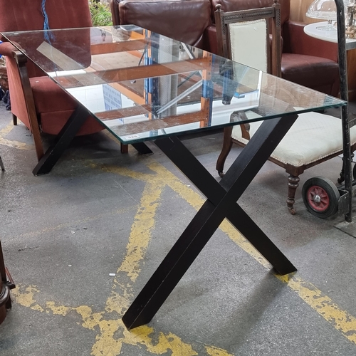 528 - Lovely glass topped dining table with wooden, X frame legs.