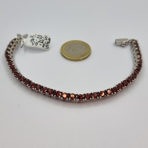 24 - Star Lot : A new sterling silver 40 stone garnet bracelet, total of 28 carats. Weight of bracelet 22... 