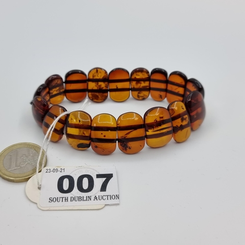 7 - A real amber expandable bracelet, containing sixteen amber beads.