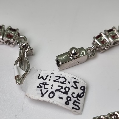24 - Star Lot : A new sterling silver 40 stone garnet bracelet, total of 28 carats. Weight of bracelet 22... 