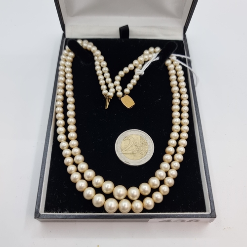 438 - A very nice example of a vintage two strand graduated pearl necklace, with 9K gold clasp (stamped 9C... 