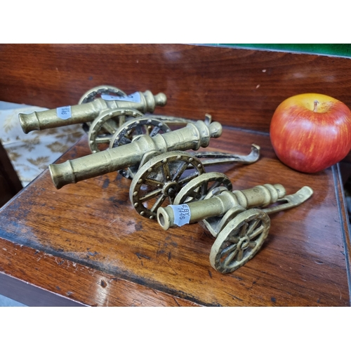583 - Three vintage brass cannons with moving parts.