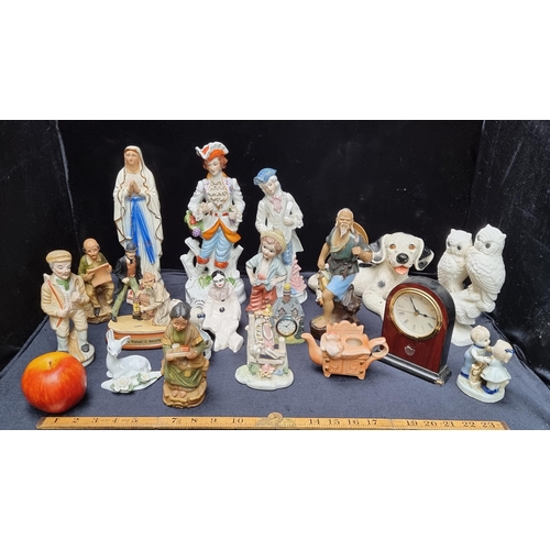 585 - A very large collection of decorative items, including a porcelain musician figurine playing a lute ... 
