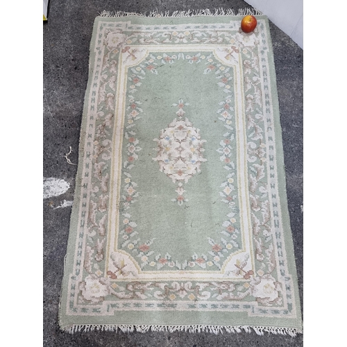 681 - A good sized vintage handmade chainese rug with a lovely floral border and fringed edges. In pretty ... 