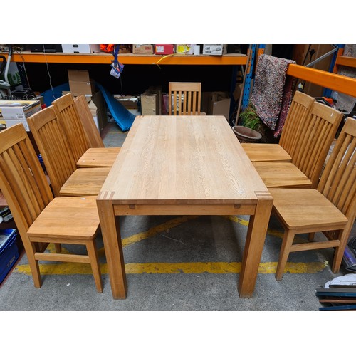 397 - Star Lot : A nine piece contemporary oak dining suite, consisting of an extendable dining table and ... 
