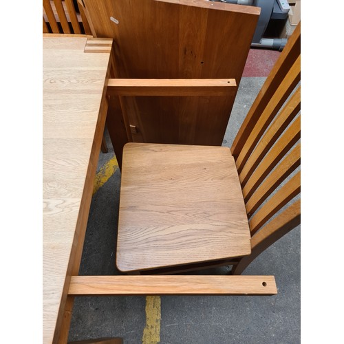 397 - Star Lot : A nine piece contemporary oak dining suite, consisting of an extendable dining table and ... 
