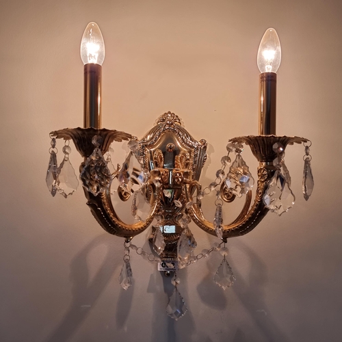 2 - A pair of Italian opulent brass two-branch wall sconces adorned with leaf-drop crystals in beautiful... 