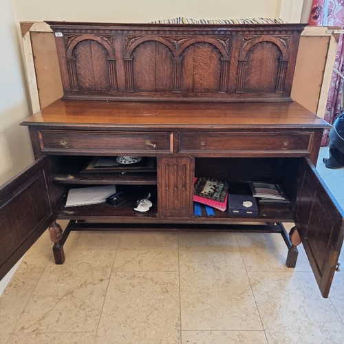 3 - A 1920's mahogany Side board with a high gallery back, Queen Anne drop handles and classically carve... 