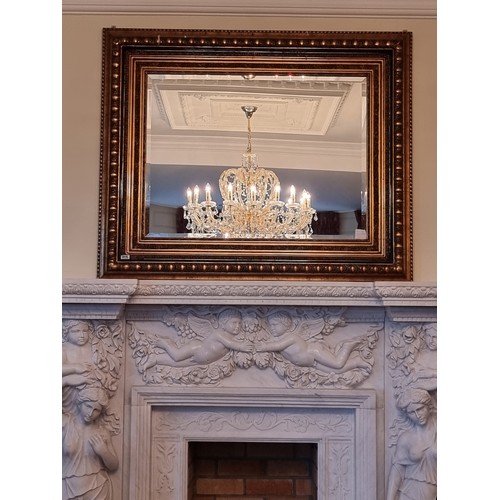 15 - A huge bevelled thick framed over-mantle mirror with broad gilt frame. Beautifully carved. H116cm x ... 