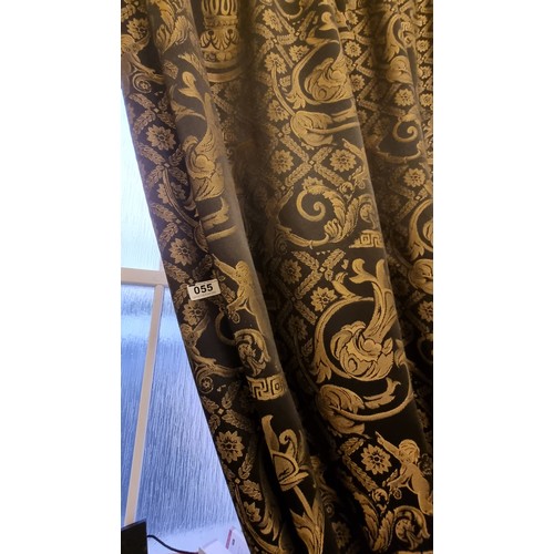 55 - A large brushed chrome curtain rail with acorn ends. With a lovely full length lined curtain upholst... 