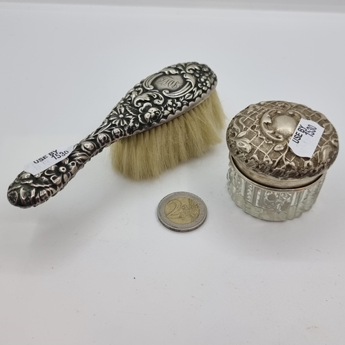 21 - A sterling silver brush with floral and initial detail. Together with a sterling silver topped dress... 