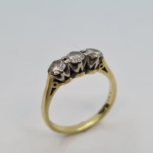8 - Star Lot: A very attractive three stone diamond ring, diamonds set in gold (marks indistinct). Total... 