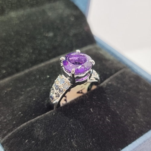 12 - Star Lot: A large super impressive new amethyst ring with sapphire set shoulders. Set in sterling si... 