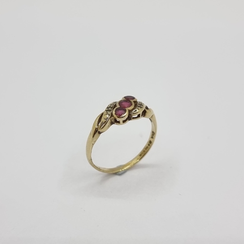 3 - A nice example of a 9K gold three stone ruby ring with diamond shoulders on twist setting. Ring size... 