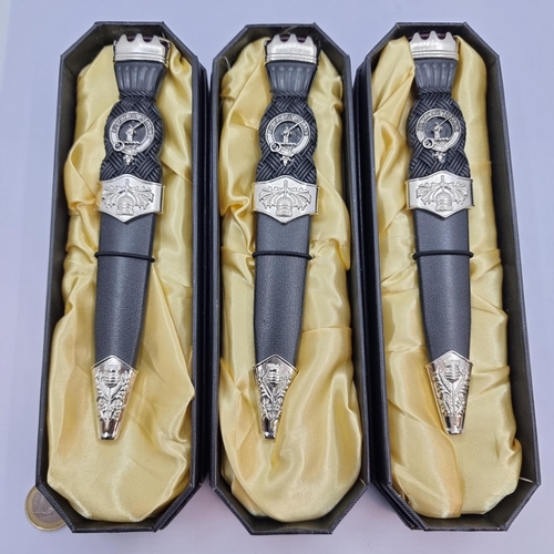 A collection of three Scottish dirks/daggers. Featuring Scottish thistle and agate stone set handle. Length of dagger 18cm, length of blade 9cm. All in as new condition, in presentation cases.