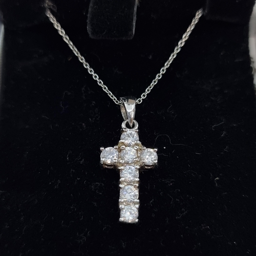 50 - A sterling silver cross drop pendant. Cross set with CZ stones. Length of necklace 44cm.
