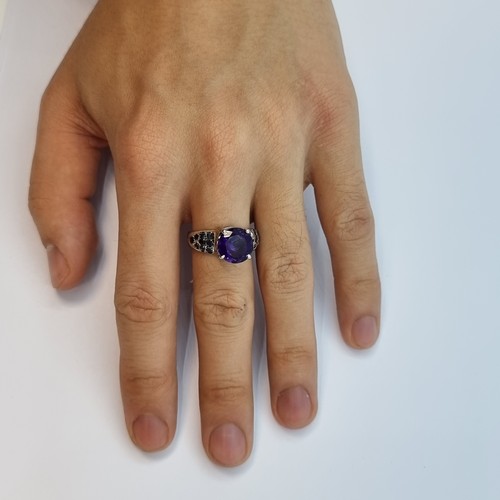12 - Star Lot: A large super impressive new amethyst ring with sapphire set shoulders. Set in sterling si... 