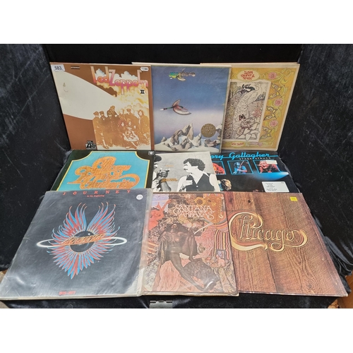 A collection of 14 vinyl records, mostly rock and pop including Led Zeppelin II, Santana, and Journey's "In The Beginning". Rory Gallagher all bangers no fillers.