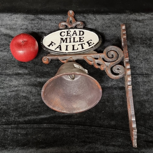 A heavy cast iron vintage wall mounted door bell with "Cead Mile Failte" on both sides