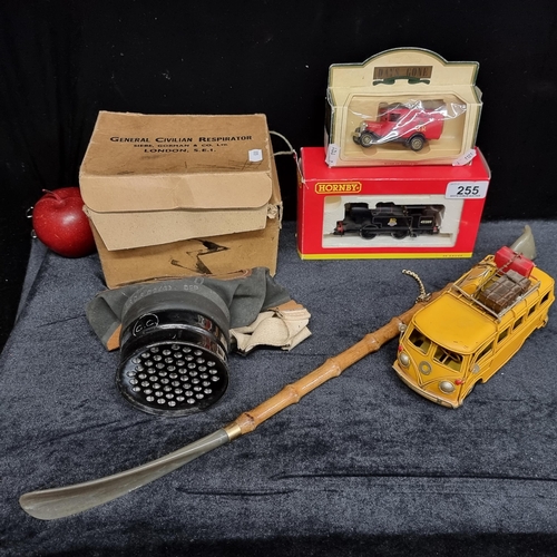 A mixed lot of five items including three vintage model cars and train, a vintage general civilian respirator in its original box and a back scratcher/shoe horn.