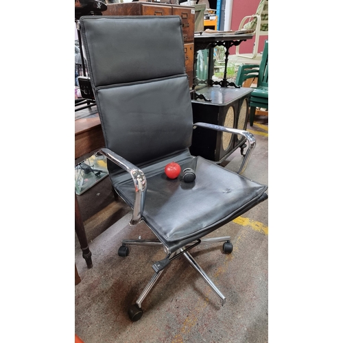 A high quality office swivel chair after Eames design, with tubular chrome arm rests and adjustable height seat, upholstered in black leather fabric We will put on a new castor for you prior to collection.