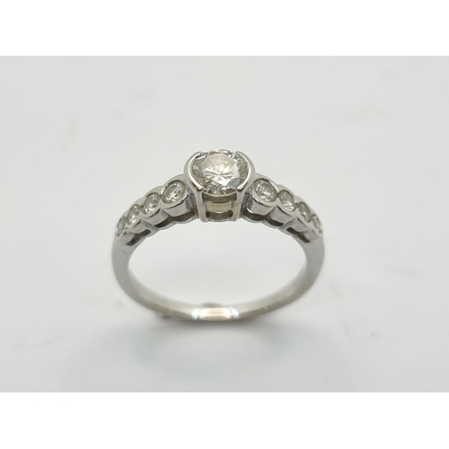 22 - Star Lot: A very attractive 18k white gold diamond ring. Weight of centre diamond 0.65cts. Ring size... 