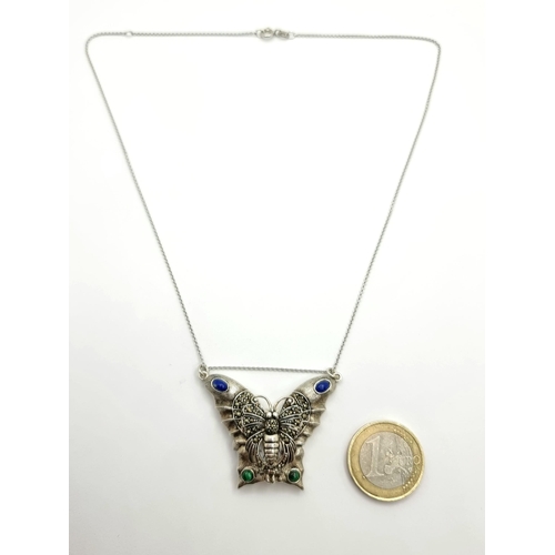 541 - A pretty butterfly pendant with jade and lapis lazuli stone accents. With inlaid watch. With silver ... 