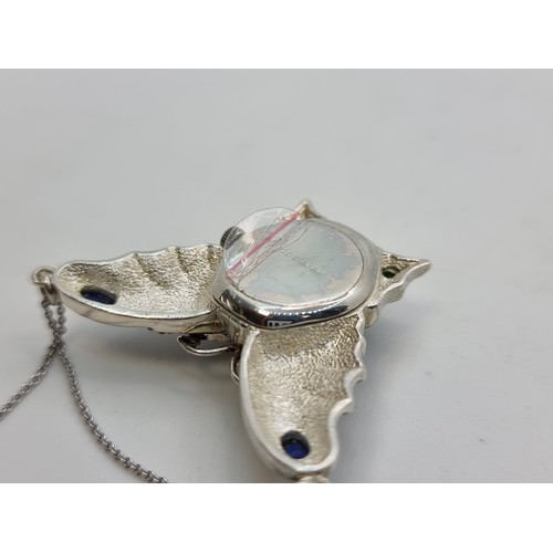 541 - A pretty butterfly pendant with jade and lapis lazuli stone accents. With inlaid watch. With silver ... 